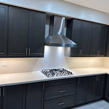 Kitchen island with quartz top and dark cabinets