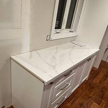 L-shaped quartz countertop with white cabinets