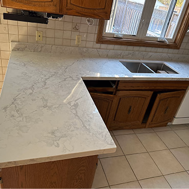 Kitchen peninsula with quartz waterfall edge