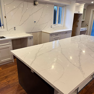 Finished kitchen with a veined white quartz countertop