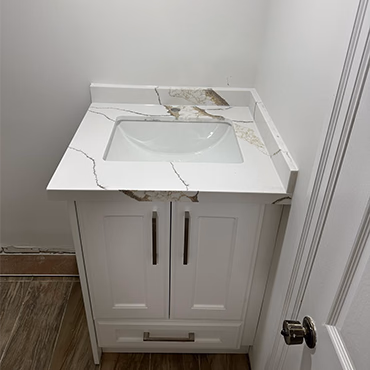 White vanity top with gold veining and an undermount sink